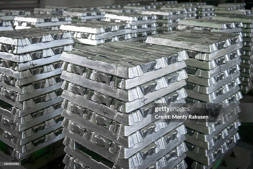 Stacked ingots in aluminium recycling plant warehouse awaiting delivery