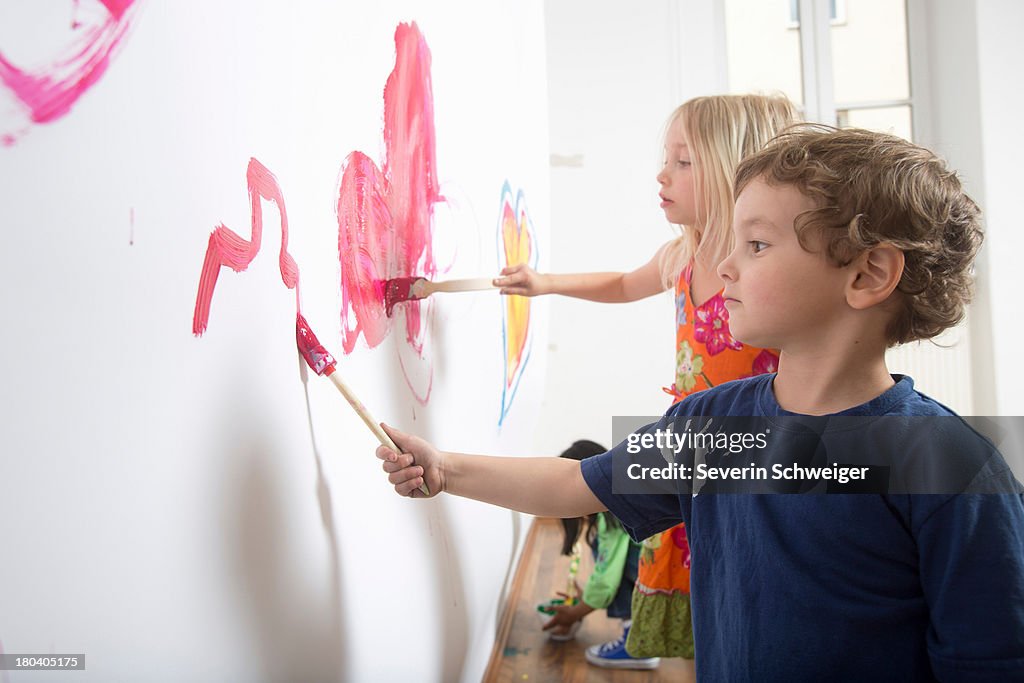 Group of children painting wall