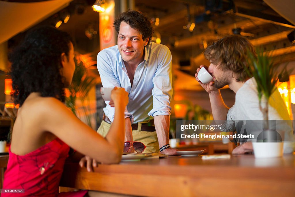 Group of friends chatting in cafe