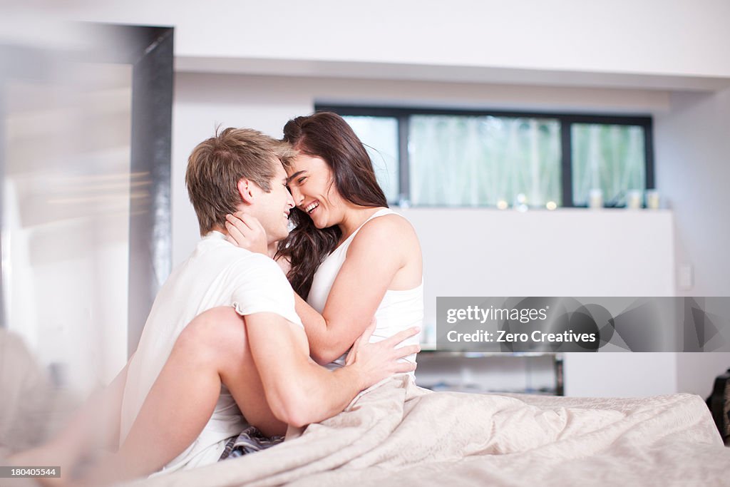 Affectionate young couple on bed