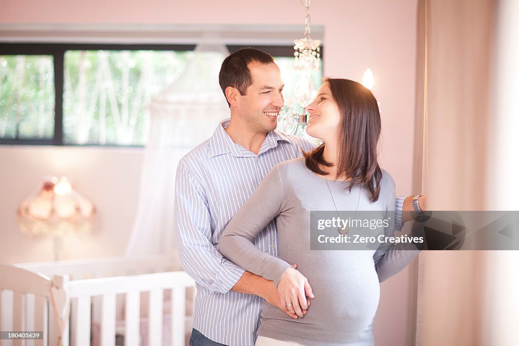 Expectant couple in nursery
