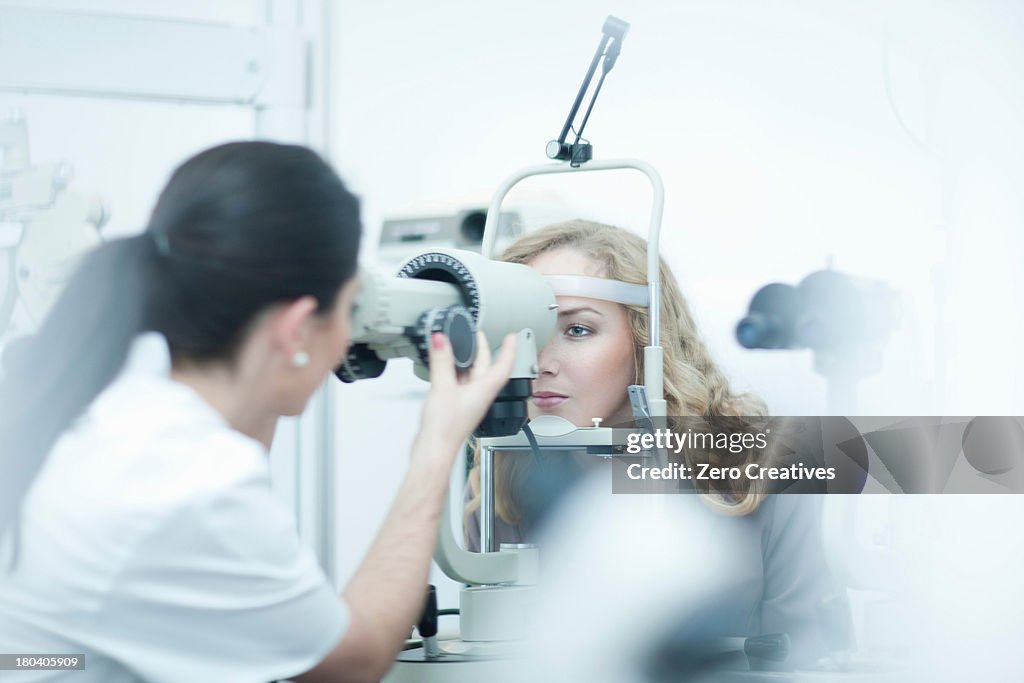 Optician and patient in eye clinic