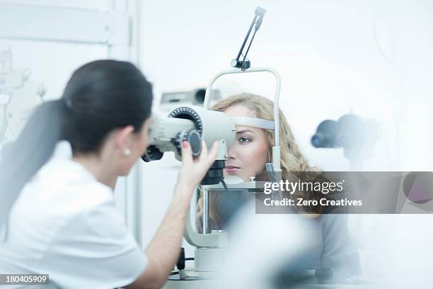 optician and patient in eye clinic - ophthalmologist stock pictures, royalty-free photos & images