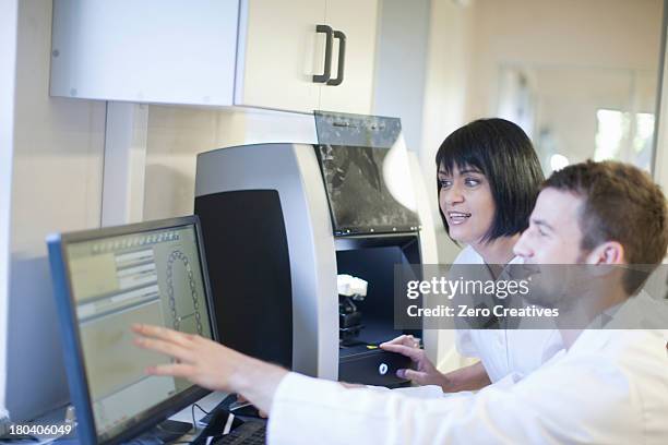 dental technicians using computer to operate dental equipment - screen replacement stock pictures, royalty-free photos & images