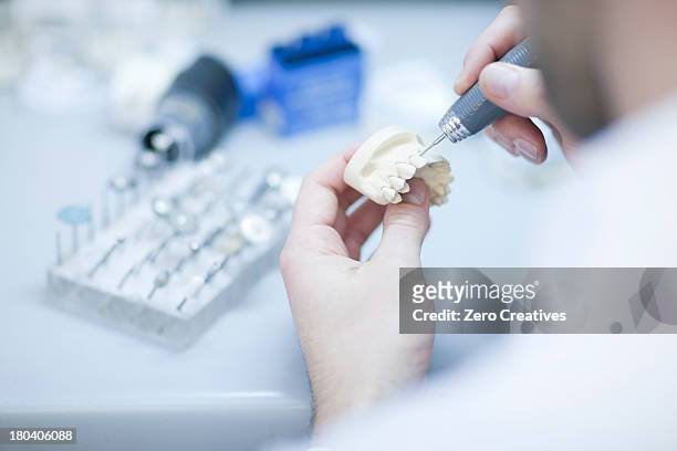 dental technician working on denture - dental assistant stock pictures, royalty-free photos & images