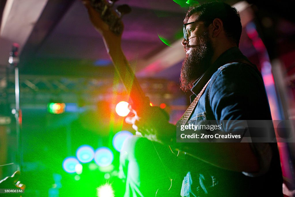 Man playing guitar in nightclub