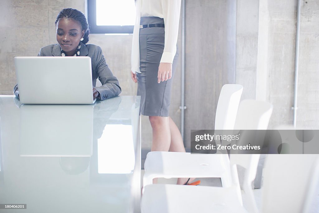 Two young women in boardroom