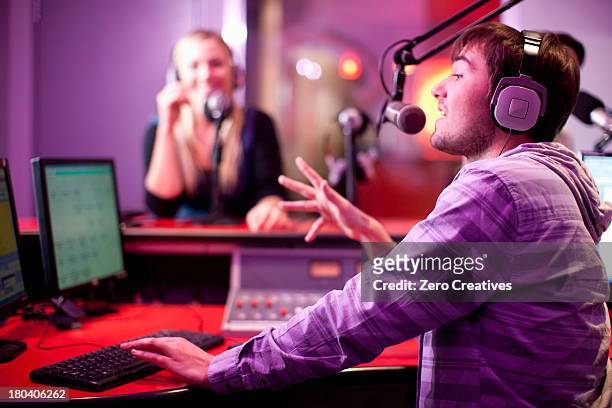 young man and woman broadcasting in recording studio - radio dj photos et images de collection