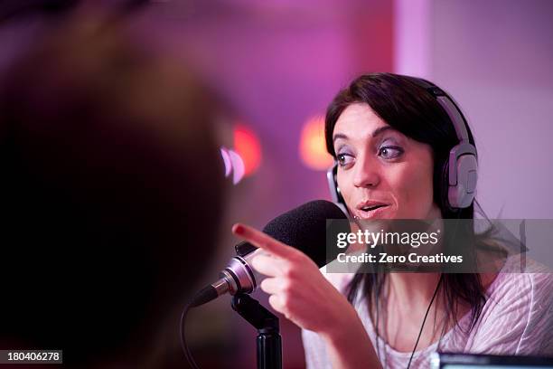 mid adult woman broadcasting in recording studio - radio dj stock pictures, royalty-free photos & images