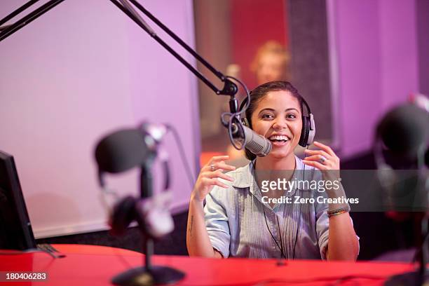 young woman broadcasting in recording studio, portrait - microphone desk fotografías e imágenes de stock