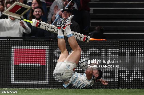 Racing 92's English full-back Henry Arundell dives and scores a try during the French Top 14 rugby union match between Racing 92 and La Rochelle at...