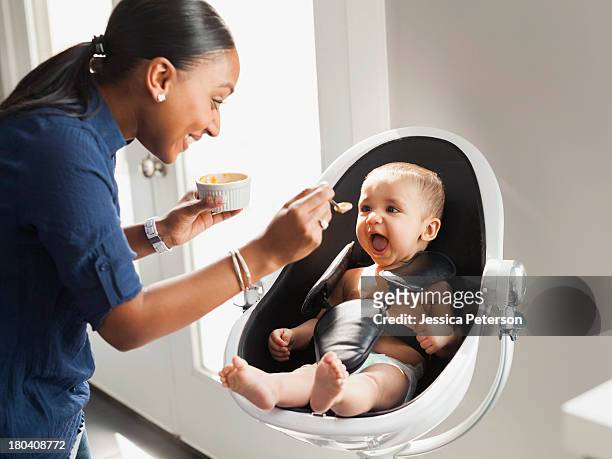 usa, utah, lehi, mother feeding baby (2-5 moths) - asian spoon feeding happy stock pictures, royalty-free photos & images