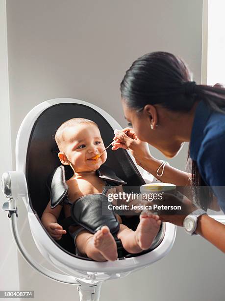 usa, utah, lehi, mother feeding baby (2-5 moths) - asian spoon feeding happy stock pictures, royalty-free photos & images