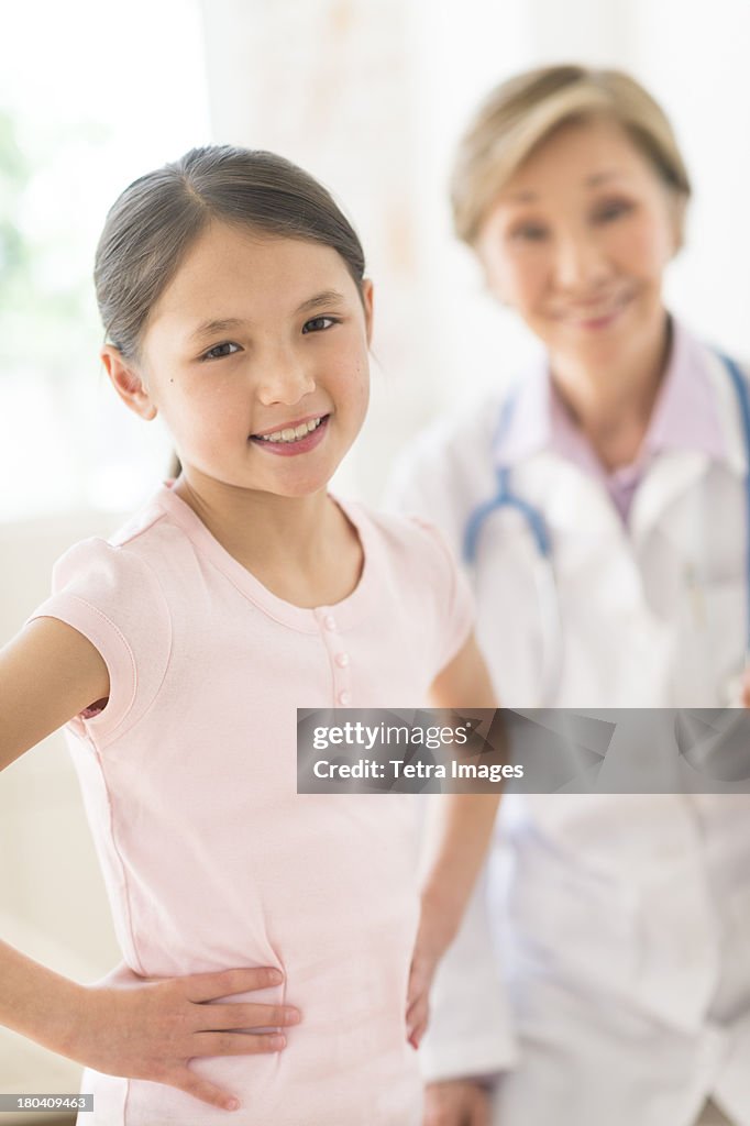 USA, New Jersey, Jersey City, Portrait of girl (8-9) and doctor in background