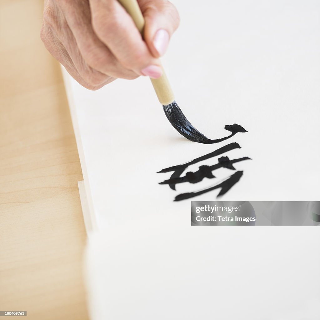 USA, New Jersey, Jersey City, Female hand and japanese calligraphy