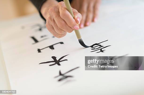 usa, new jersey, jersey city, female hand and japanese calligraphy - japanese script imagens e fotografias de stock