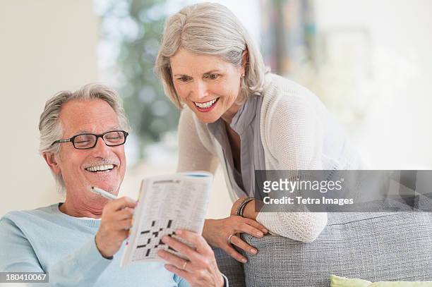 usa, new jersey, jersey city, senior couple doing crossword - word puzzle stock pictures, royalty-free photos & images