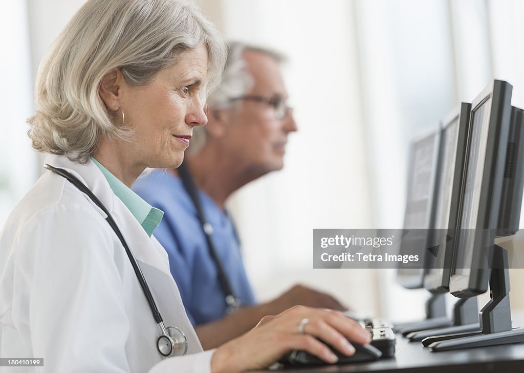 USA, New Jersey, Jersey City, Female and male doctors working at computers