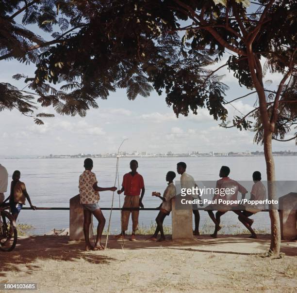 Group of young boys congregate beside the Stanley Pool section of the Congo River as it passes the city of Brazzaville, capital of the Republic of...