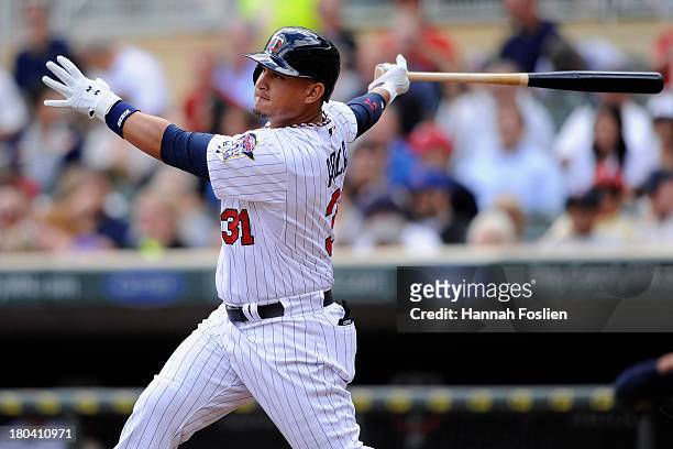 Oswaldo Arcia of the Minnesota Twins hits a solo home run against the Oakland Athletics during the seventh inning of the game on September 12, 2013...