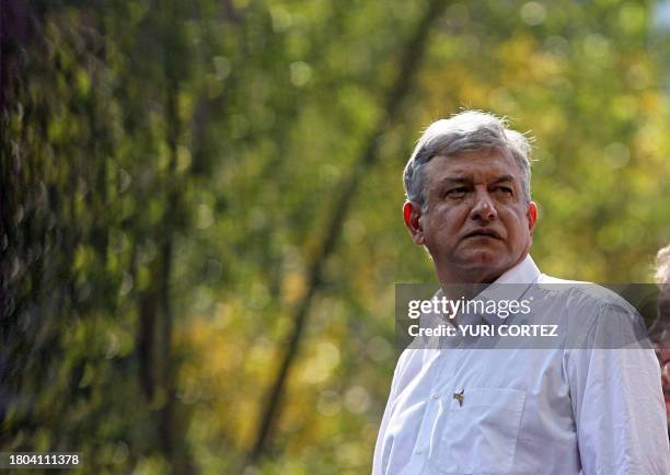 Defeated Mexican presidential candidate Andres Manuel Lopez Obrador, from the Democratic Revolution Party , looks at his supporters after delivering...