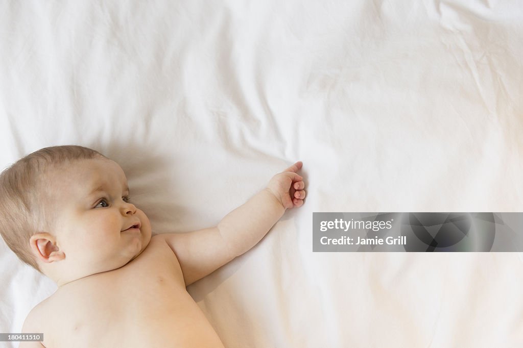 USA, New Jersey, Jersey City, Portrait of baby girl (6-11 months) lying down