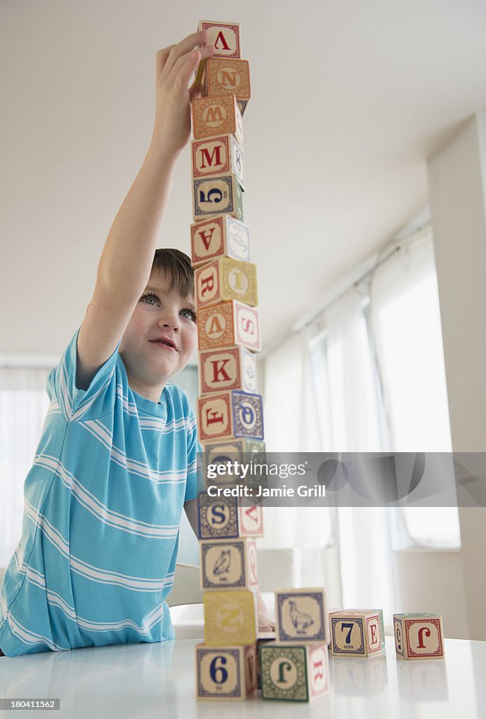 USA, New Jersey, Jersey City, Portrait of boy (4-5) building tower