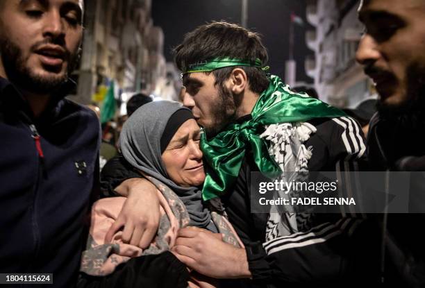 Palestinian prisoner hugs his mother after being released from an Israeli jail in exchange for Israeli hostages released by Hamas from the Gaza...