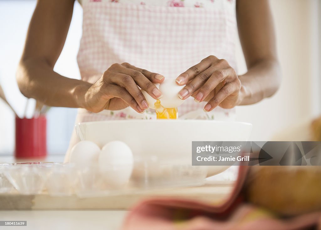 USA, New Jersey, Jersey City, Mid section of woman separating eggs