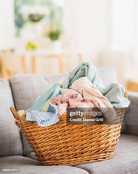 usa, new jersey, jersey city, laundry basket on sofa - laundry basket fotografías e imágenes de stock