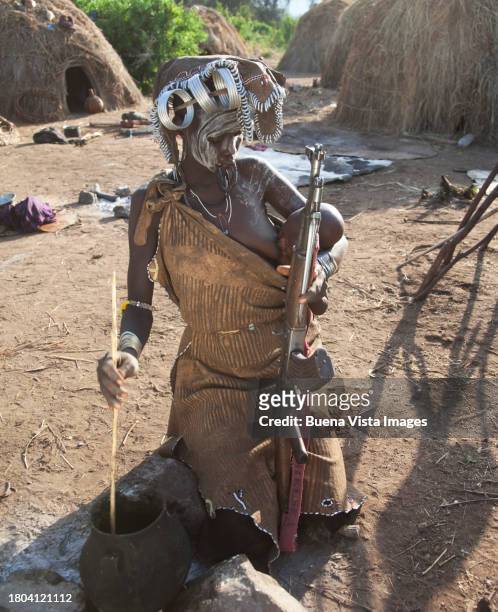 ethiopia. mursi woman with baby and gun - 1 year poor african boy stock pictures, royalty-free photos & images