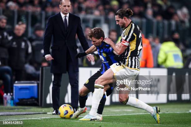 Inter midfielder Nicolo Barella is fighting for the ball against Juventus midfielder Adrien Rabiot during the Serie A football match between Juventus...