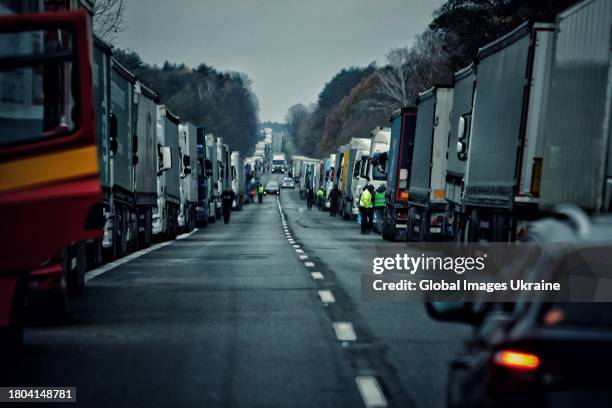Ukrainian drivers wait near their trucks, blocked by Polish protesters near the Polish Ukrainian border crossing on November 19, 2023 in Lublin...