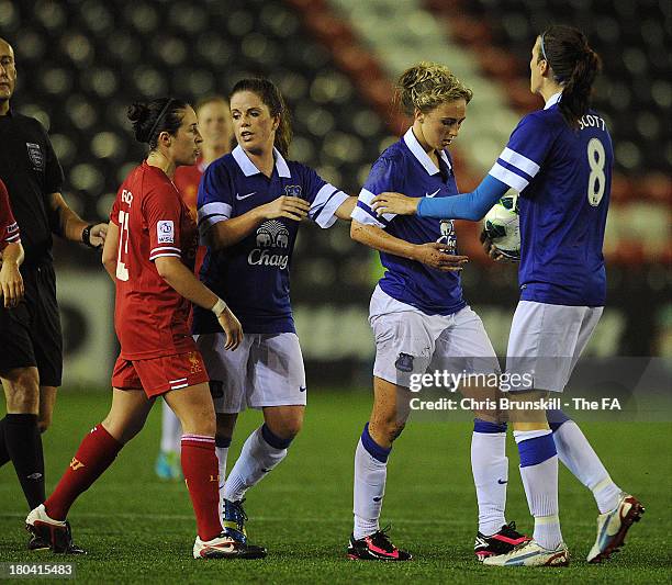 Toni Duggan of Everton Ladies FC is restrained by Jill Scott and team-mates after clashing with Nicole Rolser of Liverpool Ladies FC during the FA...