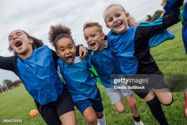 winning celebrations at football training - multi ethnic group of kids stock pictures, royalty-free photos & images