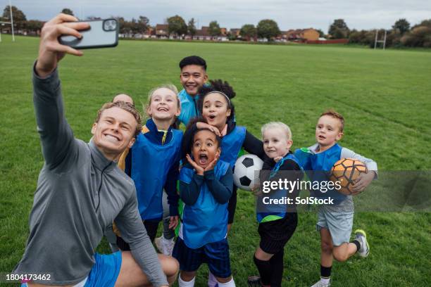 team selfie at football training - using phone football stock pictures, royalty-free photos & images