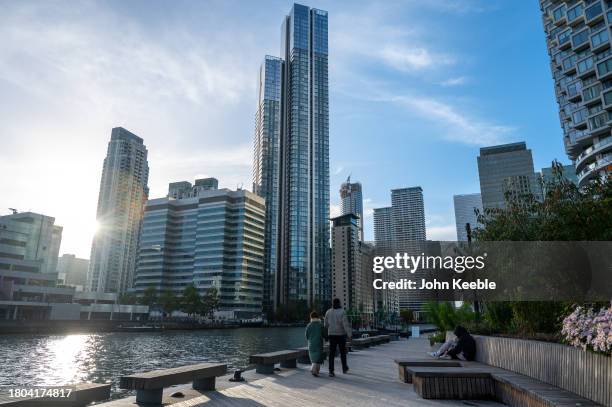 General view of the residential apartment building, Hampton Tower, South Quay Plaza as people walk along the Harbour Quay early evening at Canary...