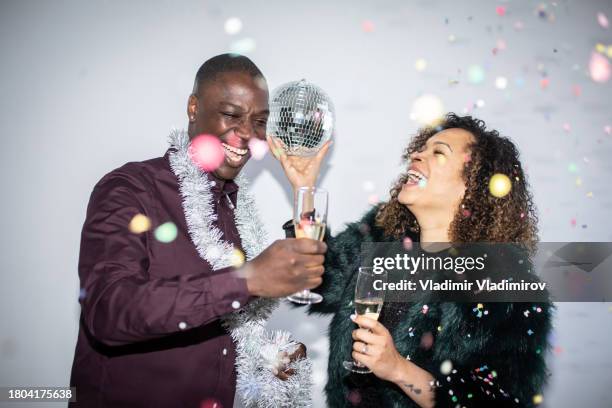 two friends holding glasses of champagne - after party stock pictures, royalty-free photos & images