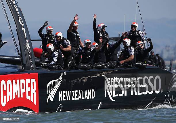 The crew of Emirates Team New Zealand skippered Dean Barker waves to the crowd after defeating Oracle Team USA skippered James Spithill during race...