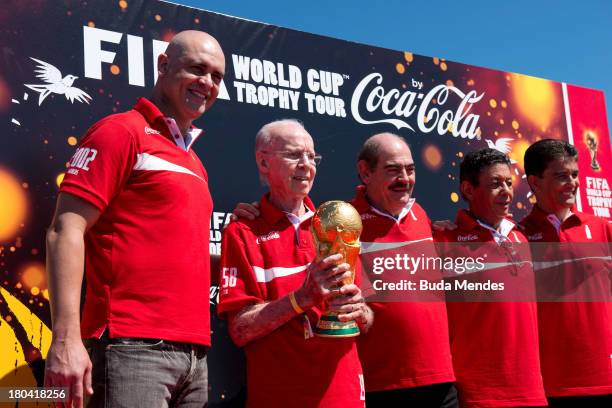 Brazilian FIFA World Cup winners Marcos, Zagallo, Rivelino, Amarildo and Bebeto pose with the trophy during the official launch of the Global FIFA...