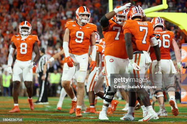 Phil Mafah of the Clemson Tigers celebrates with Mitchell Mayes of the Clemson Tigers after scoring a touchdown against the North Carolina Tar Heels...