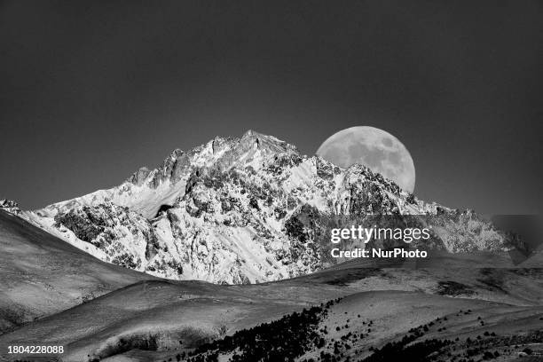 Photo has been converted in black and white colors) Beaver full moon rising above Monte Prena Mountain is seen from L'Aquila, Italy, on November...