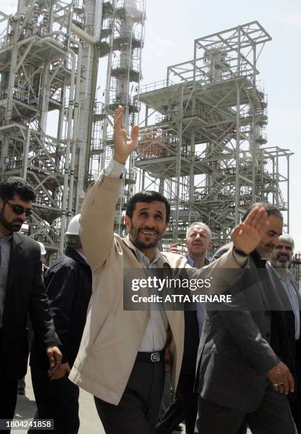 Iranian President Mahmoud Ahmadinejad waves during the opening ceremony of a heavy water plant in Arak, 320 kms south of Tehran, 26 August 2006....