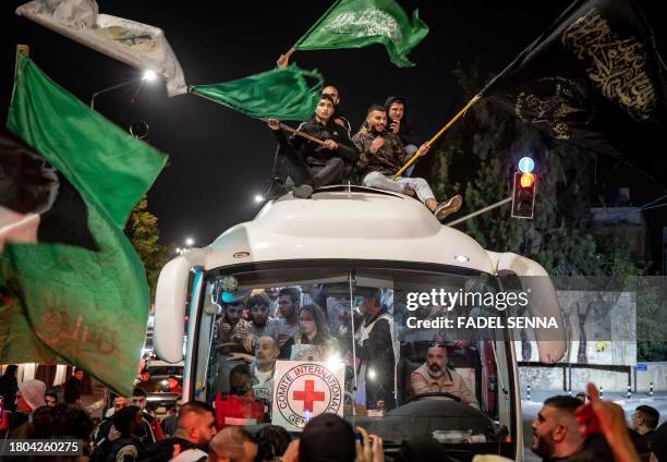 Crowd surrounds a Red Cross bus carrying Palestinian prisoners released from Israeli jails in exchange for hostages released by Hamas from the Gaza...