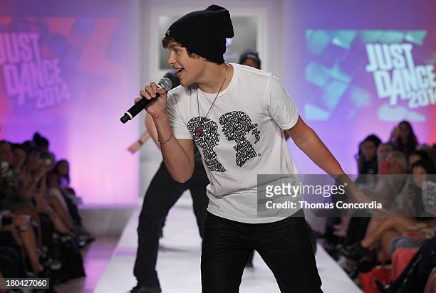 Recording artist Austin Mahone performs on the runway during Just Dance with Boy Meets Girl show at the STYLE360 Fashion Pavilion in Chelsea on...