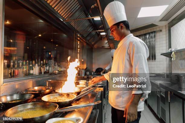 professional chefs in a commercial kitchen of a fine dining restaurant - brigade stock pictures, royalty-free photos & images