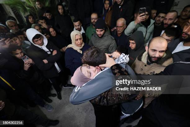 Palestinian prisoner Khalil Zama' hugs his mother after being released from an Israeli jail in exchange for Israeli hostages released by Hamas from...