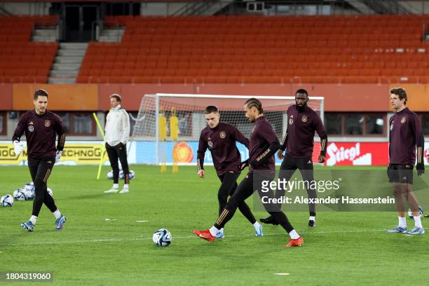Leroy Sane of Germany plays the ball with his team mate Florian Wirtz during a DFB Training Session at Ernst Happel Stadion on November 20, 2023 in...