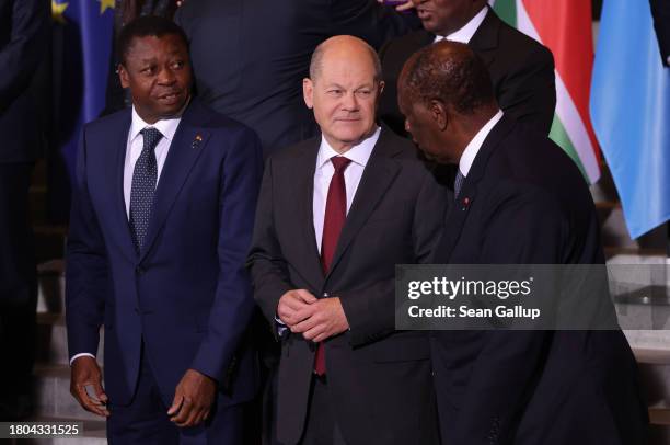 German Chancellor Olaf Scholz talks with Alassane Ouattara , President of Ivory Coast, as Faure Gnassingbe , President of Togo, looks on at the G20...