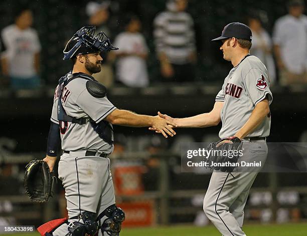 Preston Guilmet of the Cleveland Indians shakes hands with Kelly Shoppach after a win against the Chicago White Sox at U.S. Cellular Field on...